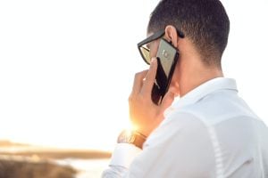 Man on telephone represents how YakTrak helps performance management and remediation.