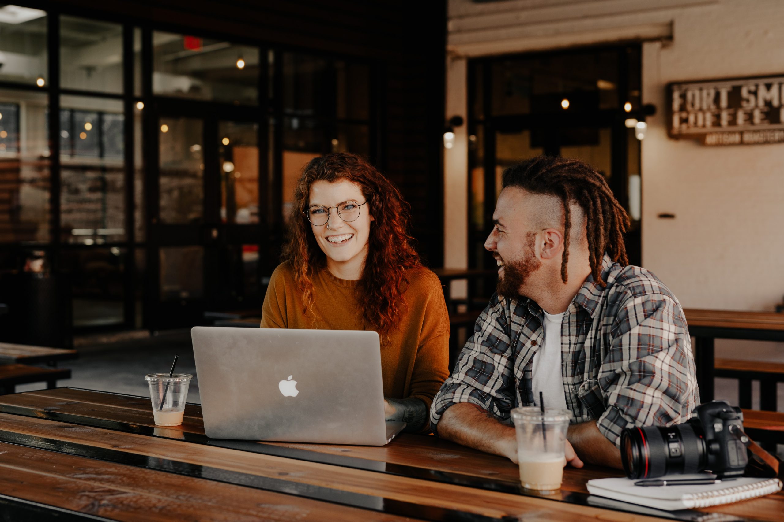 Performance coaching involves goal setting and regular meetings. Two people at a desk